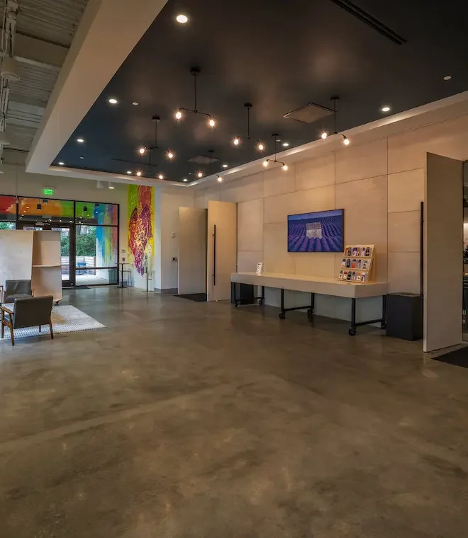Church lobby entrance with welcome desk, lounge seating, and wall-mounted digital signage