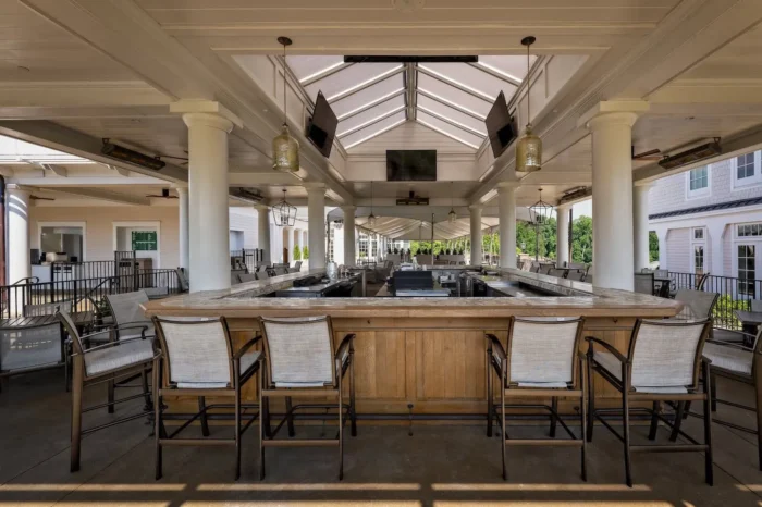 Outdoor covered bar at Druid Hills Golf Club featuring integrated AV displays, speakers, and lighting solutions installed by Macrotek Services.
