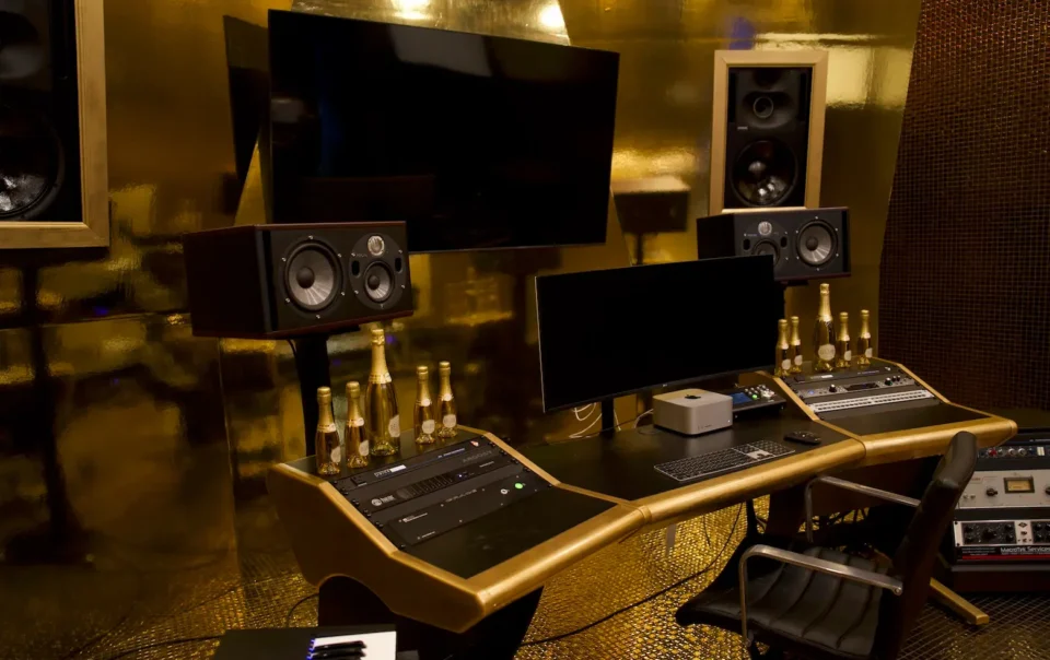 Immersive audio-visual control room with gold paneling, showcasing Sovereign Liquor’s premium brand experience