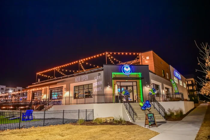 Nighttime view of Pickle and Social Buford with custom AV lighting and signage installed by Macrotek Services