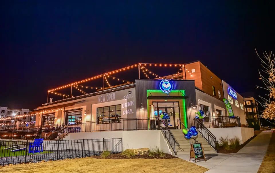 Nighttime view of Pickle and Social Buford with custom AV lighting and signage installed by Macrotek Services