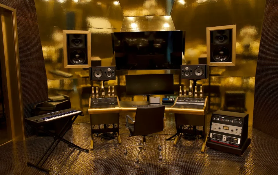 Gold-accented mixing suite at Sovereign Sound Studios featuring Macrotek-integrated AV and studio technology