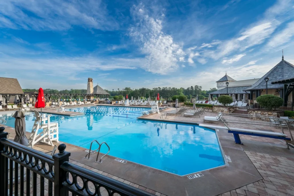 Private club pool area where discreet video surveillance helps ensure safety without disrupting member relaxation