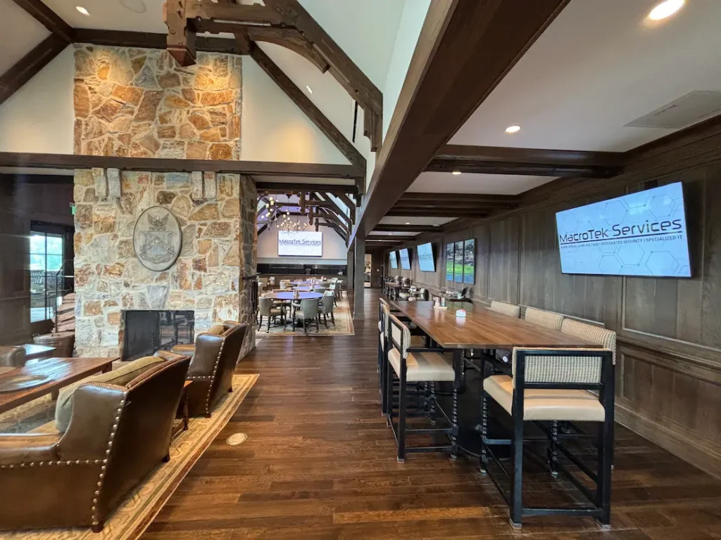 Private club conference room with wall-mounted display, audio system, and professional AV design